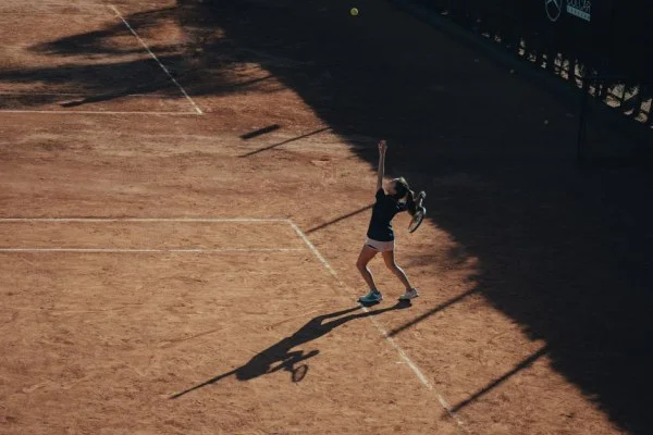female tennis player serving